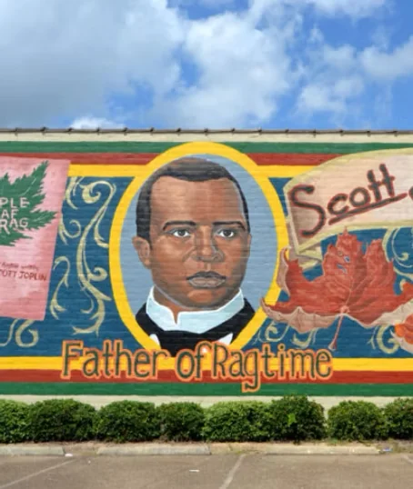 Scott Joplin Father of Ragtime mural, his portrait framed by ragtime sheet music, downtown Texarkana